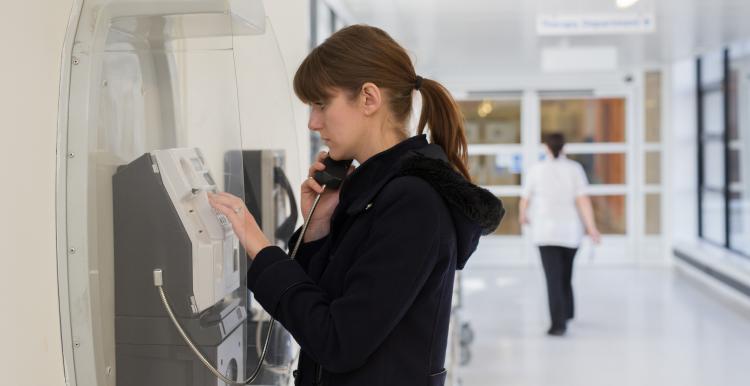 Woman at payphone