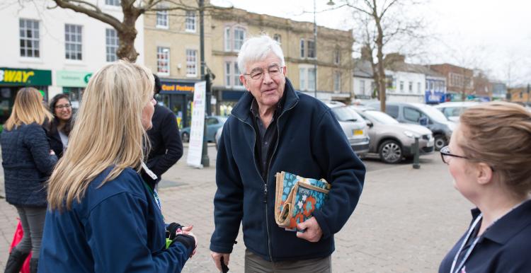 Man with walking stick talking to Healthwatch