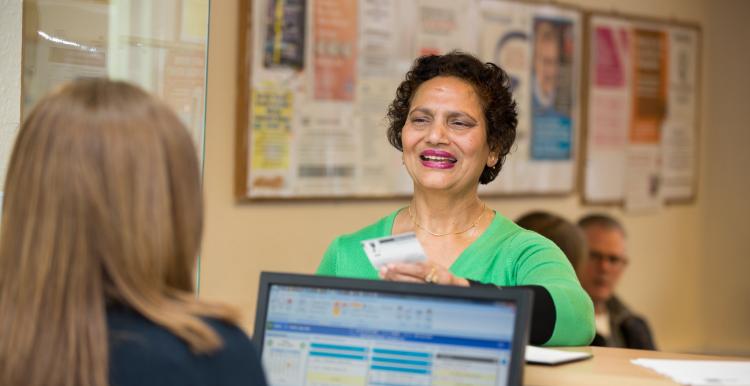 Woman talking to receptionist